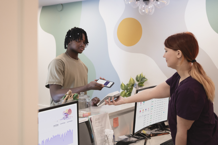 A person making an in-person payment using the Helcim Smart Terminal