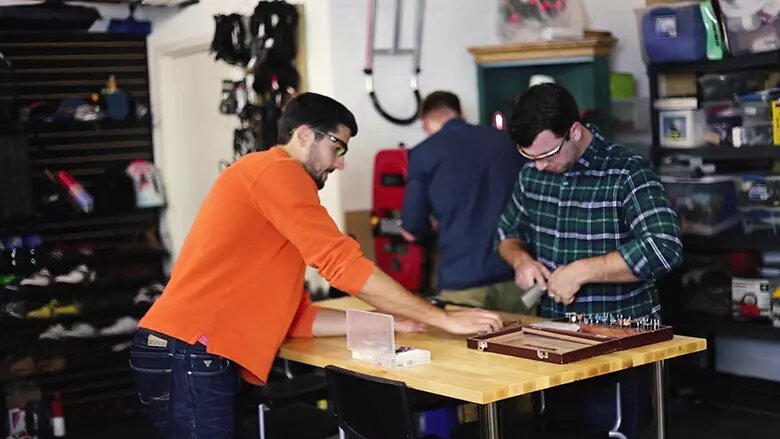Kevin Mako working on an invention project with a team member at Mako