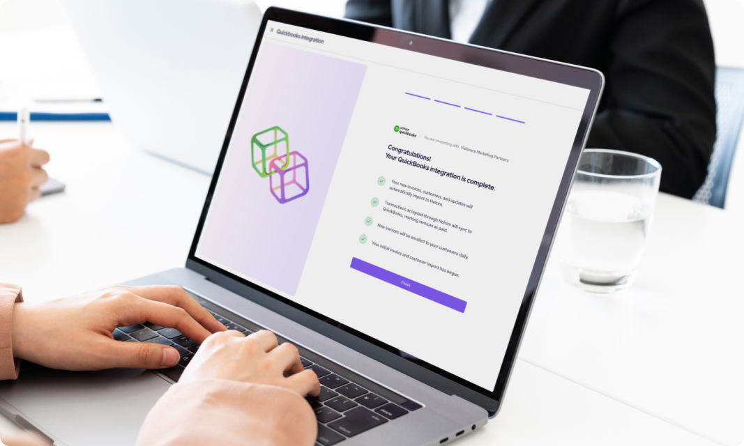 Merchant on their laptop integrating their quickbooks online account with Helcim.
