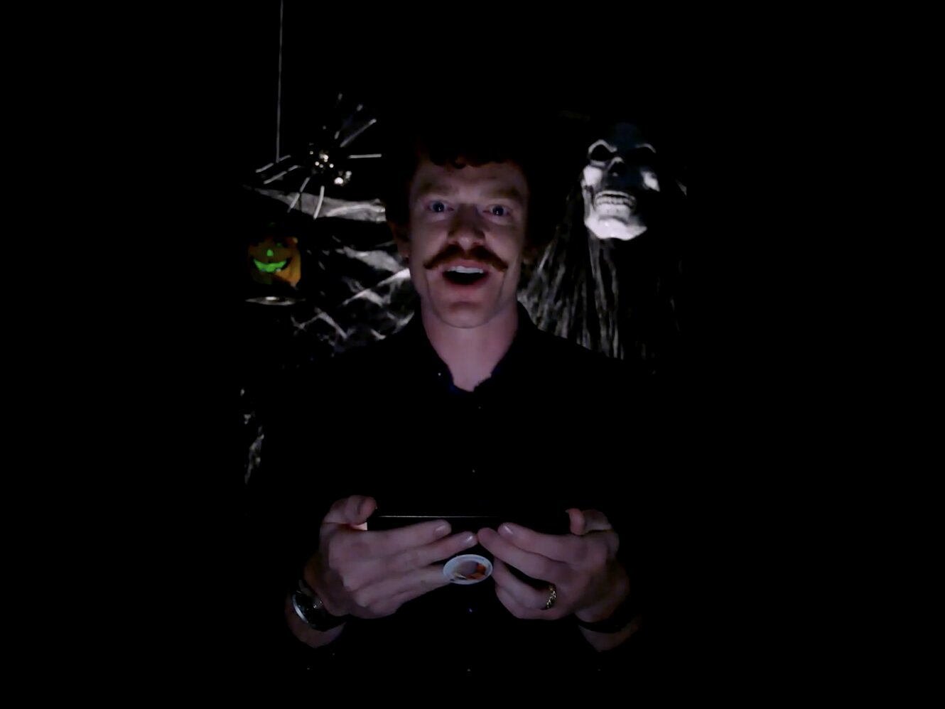 person reading scary stories in a dark room